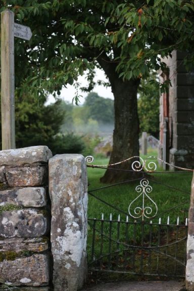 St Patrick's churchyard An image looking through the wrought iron gate into the church yard at St Patrick's Church at Bampton Grange
