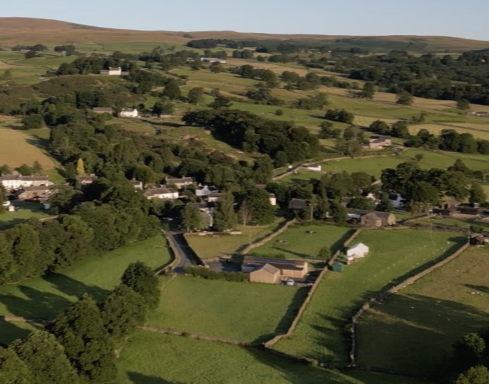 Village Halls An aerial image taken looking down towards the village halls set in the fields around Bampton