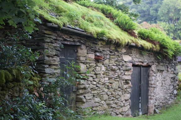 Traditional buildings A moss covered roof stone farm building