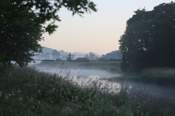 Swing Bridge Man running across swing bridge over the River Lowther