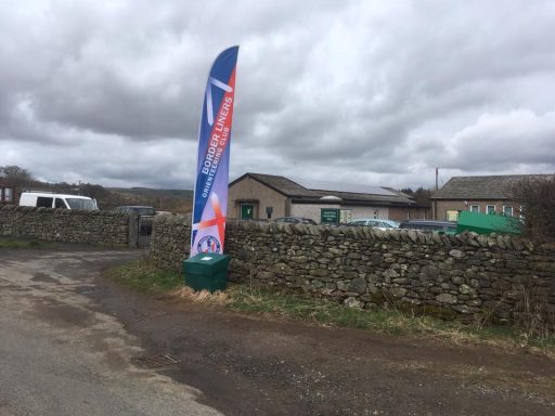 Activity Events A flag type banner stands for an Orienteering event outside the entrance to Bampton Village hall, Cumbria, The lake District