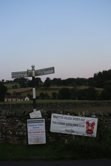 Signs old & new A traditional road sign with additional events signs found at Bomby in the parish of Bampton, The Lake District